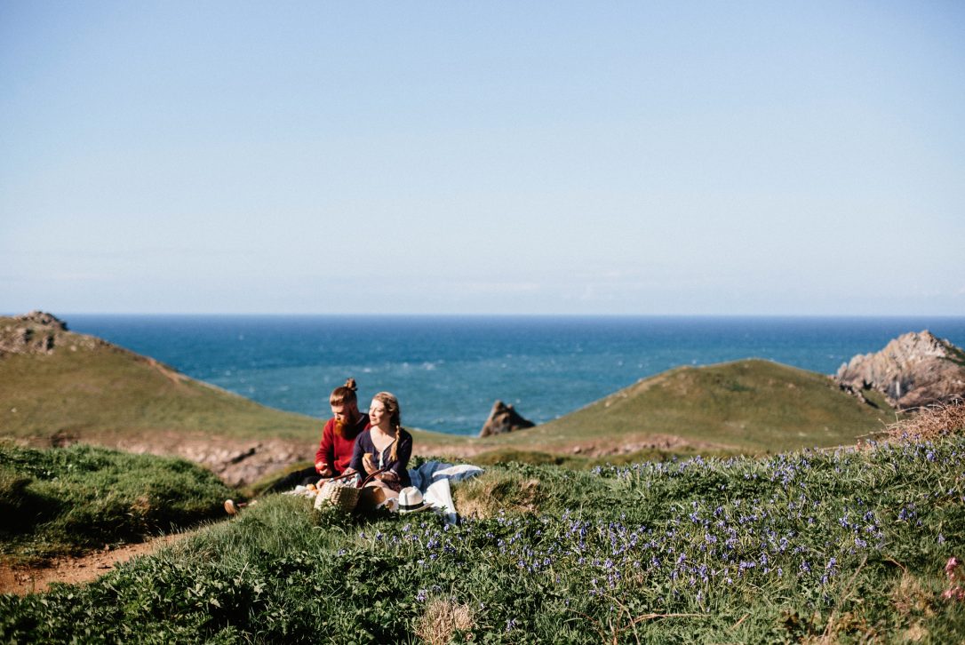 A couple enjoying a picnic at The Rumps in Cornwall