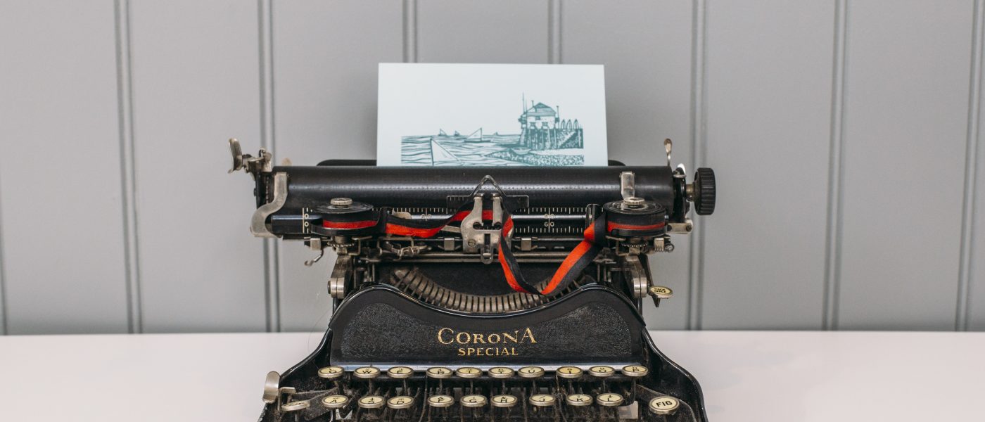A Latitude50 postcard and typewriter