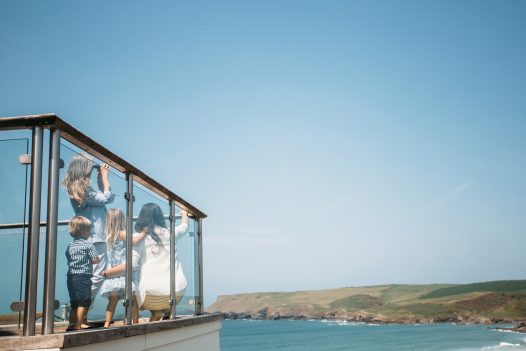 Chidren enjoying the view across Polzeath from the balcony