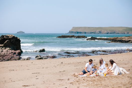 Family enjoying a picnic on Greenaway Beach