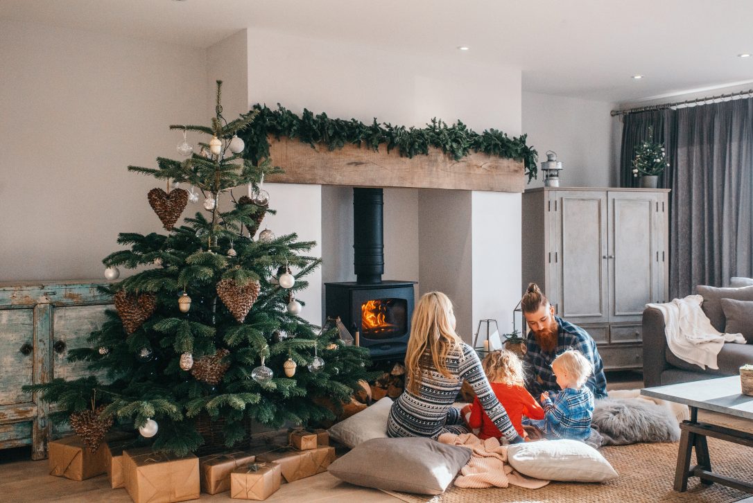 Family around the log burner at Christmas