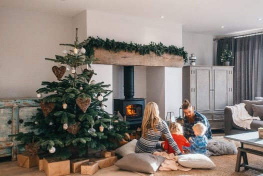 Family around the log burner at Christmas