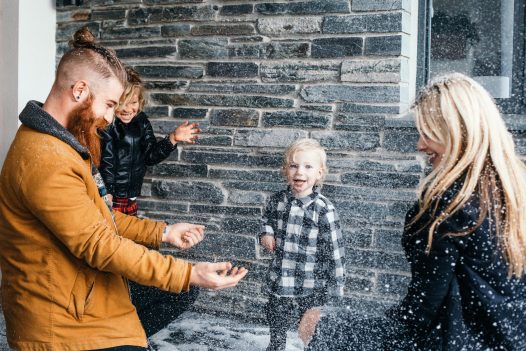 Family playing in the snow in Cornwall