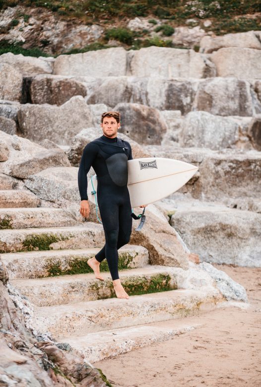 Surfer at Polzeath beach, North Cornwall