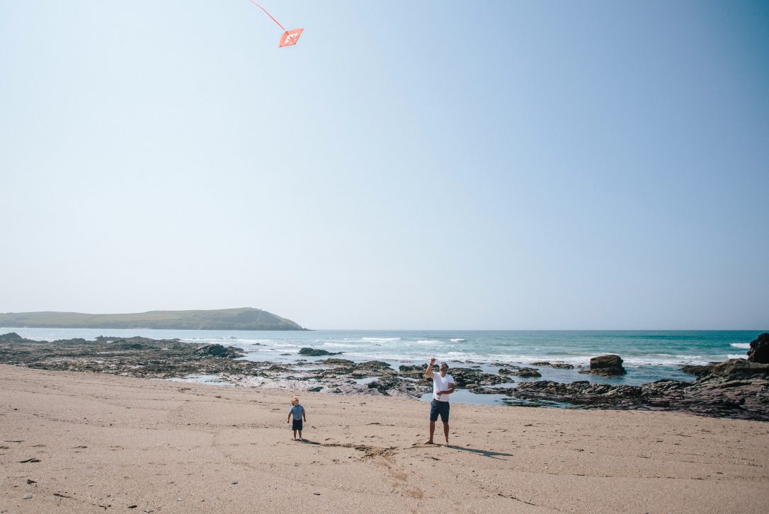 Family playing on Greenaway beach, near Polzeath, North Cornwall