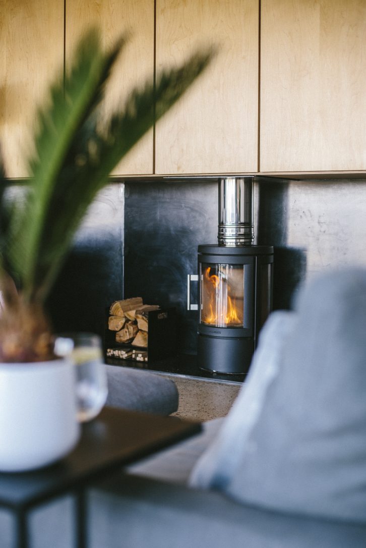 Log burner at Dry Creek House, a self-catering eco home in Polzeath, North Cornwall