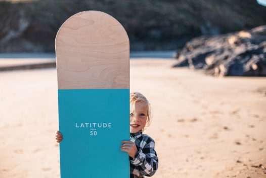 Child with bellyboard on Polzeath Beach, North Cornwall