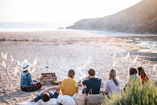 Friends and family enjoying a beach barbecue at Baby Bay, New Polzeath