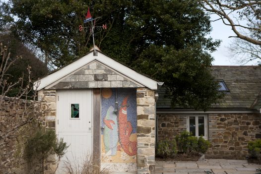 Penquite cottage's outside shower decorated with bright mosaics