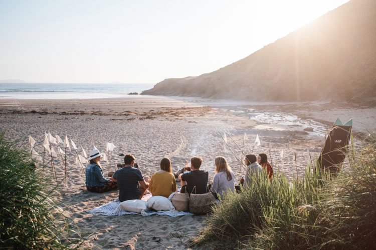 A group enjoying an evening at Baby Bay, Polzeath