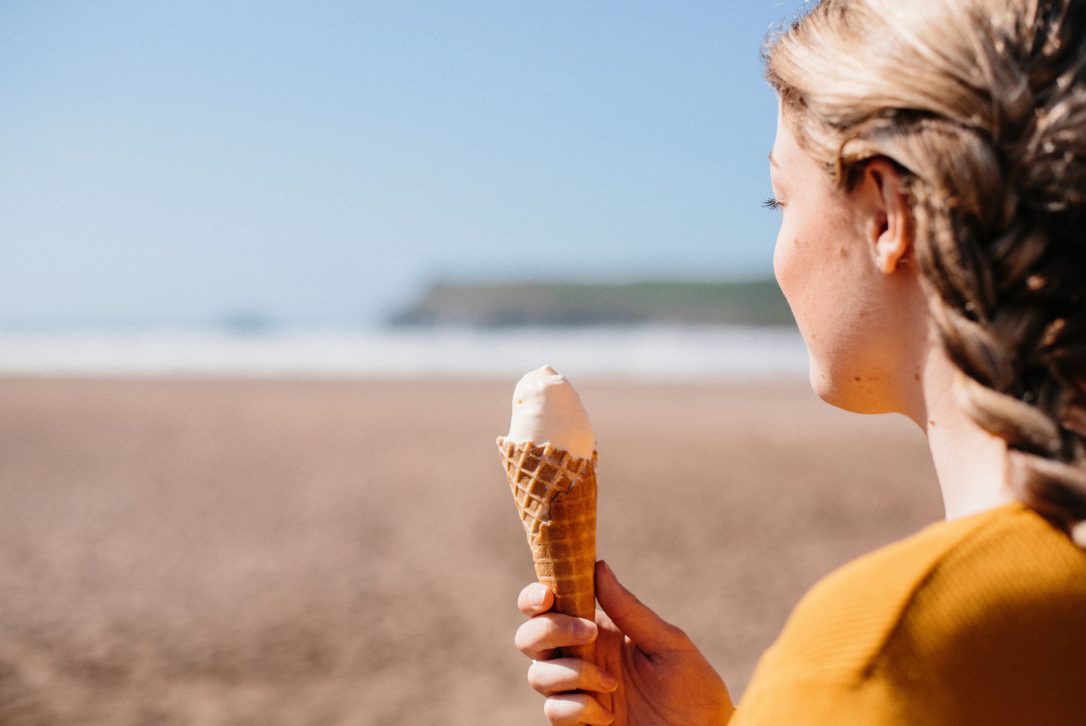 Girl enjoying an ice-cream on Polzeath Beach