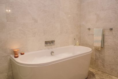 Bath tub Bedroom two is beautifully decorated with a calming coastal colour pallette