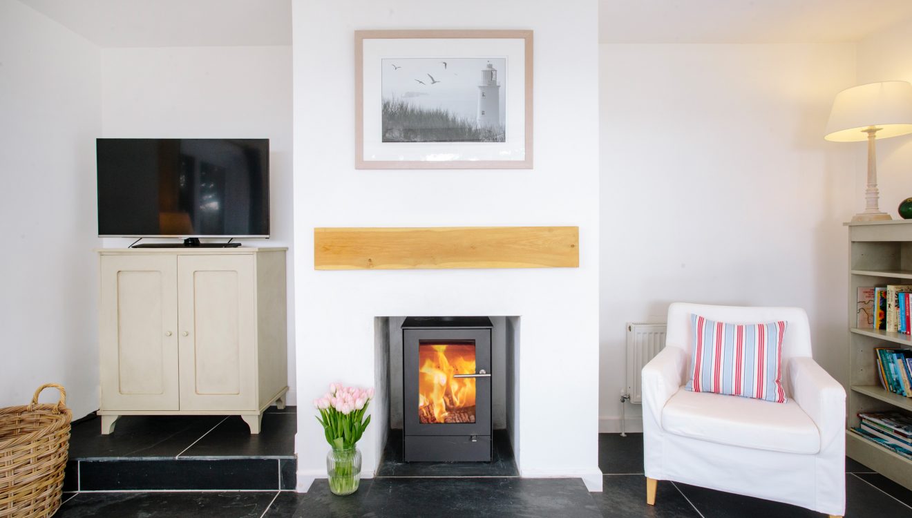 Log burner at Badger Cottage, a self-catering holiday home in Rock, North Cornwall