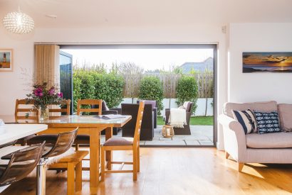 Dining area and view to garden at Clifden, a self-catering holiday house in New Polzeath, North Cornwall