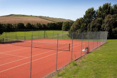 Shared tennis court at Cant Farm,  a private estate near Rock on the banks on the Camel Estuary