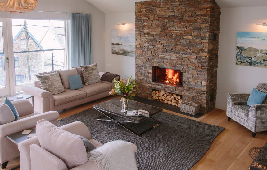 Living room with fire at Rosemar, a self-catering holiday home in New Polzeath, North Cornwall