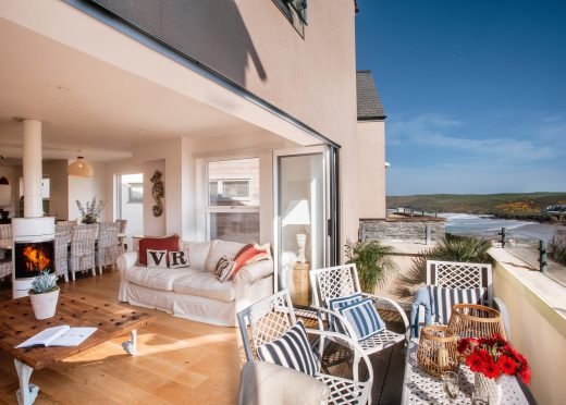 Living space and balcony at Vinnick Rock, a self-catering holiday home in Polzeath, North Cornwall